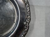 a silver plate on a table with a white table cloth