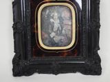 a picture of a woman in a picture frame hanging on a wall