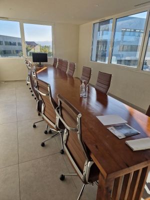 tables and chairs in a conference room with a view of the city
