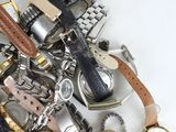 a pile of assorted watches and watches on a table