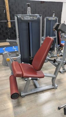 a gym room with a row of machines and other equipment