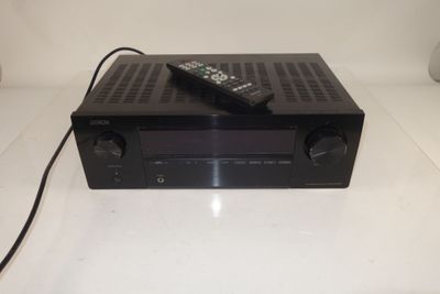 an image of a remote control sitting on top of a receiver