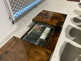 a coffee table with a glass top on a tiled floor