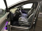 the interior of a car with the door open and the passenger seat down