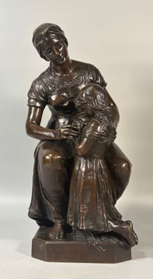 bronze statue of a woman holding a child on a wooden base