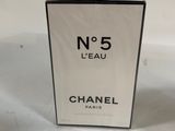 a close up of a box of perfume on a white surface