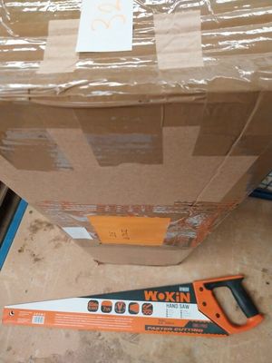 a box and a saw on the floor next to a box