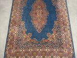 an image of a blue and red rug on a white floor