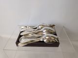 a display of silverware in a clear box