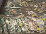 many bags of stamps on a table covered in plastic