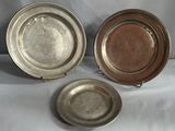 three silver plates with handles and handles on a white background
