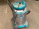 a vacuum that is sitting on the ground in the garage