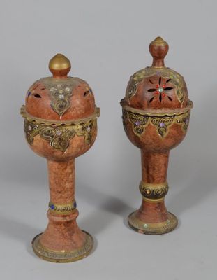 two vases sitting next to each other on a table