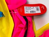 a pink and yellow jacket with a red tag on it