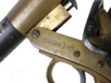 a close up of a gun that is on a white surface