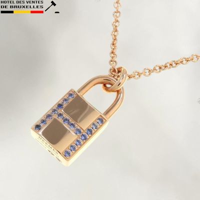 a gold necklace with a padlock on it