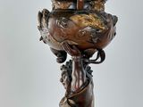 an image of a statue of a woman holding a bowl on her head