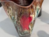 three vases that are sitting on a table