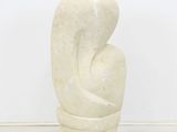 marble sculpture of a woman ' s torso on a pedestal in front of a white wall