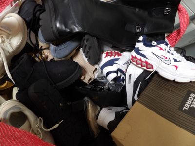 a pile of shoes and a box on the floor