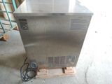 an image of a stainless steel freezer sitting on a pallet