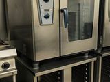 many stainless steel ovens lined up in a kitchen
