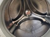 a close up of a washing machine with a pair of scissors inside of it