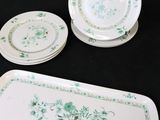 three plates and two trays on a black table