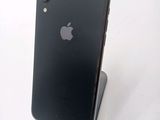 an apple iphone is sitting on top of a stand on a white surface