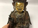 antique chinese bronze buddha statue with hand holding a small bird