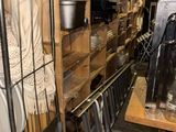 a small room with a lot of shelves and a lot of pots and pans