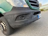a green van that is parked on the side of the road