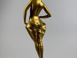 bronze statue of a woman standing on a marble base