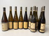 several bottles of wine are lined up in a row on a table