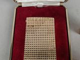 an image of a gold plated cigarette case in a red velvet box