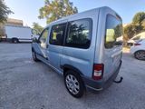 a small blue van parked in a parking lot next to other cars