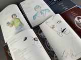 a lot of drawings on the pages of a book