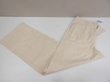 a pair of beige pants sitting on top of a white table