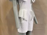 a mannequin wearing a white dress with ruffles on it