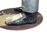 a close up of a metal object with a shoe on it