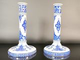 pair of blue and white candlesticks on a black table