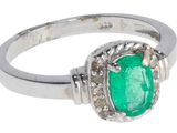 une image d'une bague avec une pierre verte entourée de diamants