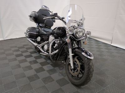 a black motorcycle that is parked on a checkered floor