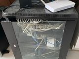 a glass cabinet with a computer and a keyboard on top of it