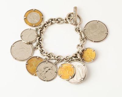 a silver bracelet with a bunch of coins on it
