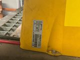 a yellow box sitting on top of a piece of metal