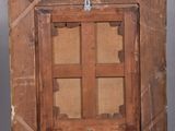 an old wooden easel with a painting on top of it