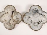 two pieces of pottery that are sitting on a table