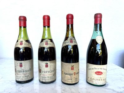 three bottles of wine are lined up on a marble table
