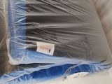 two pillows that are wrapped in plastic on the bed